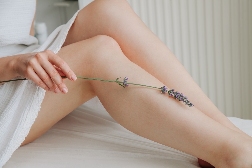 woman holding lavender stem against leg