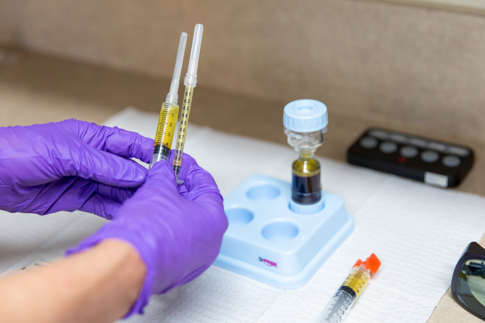 close up of gloved hands preparing a vaginal dryness treatment in Oklahoma City.