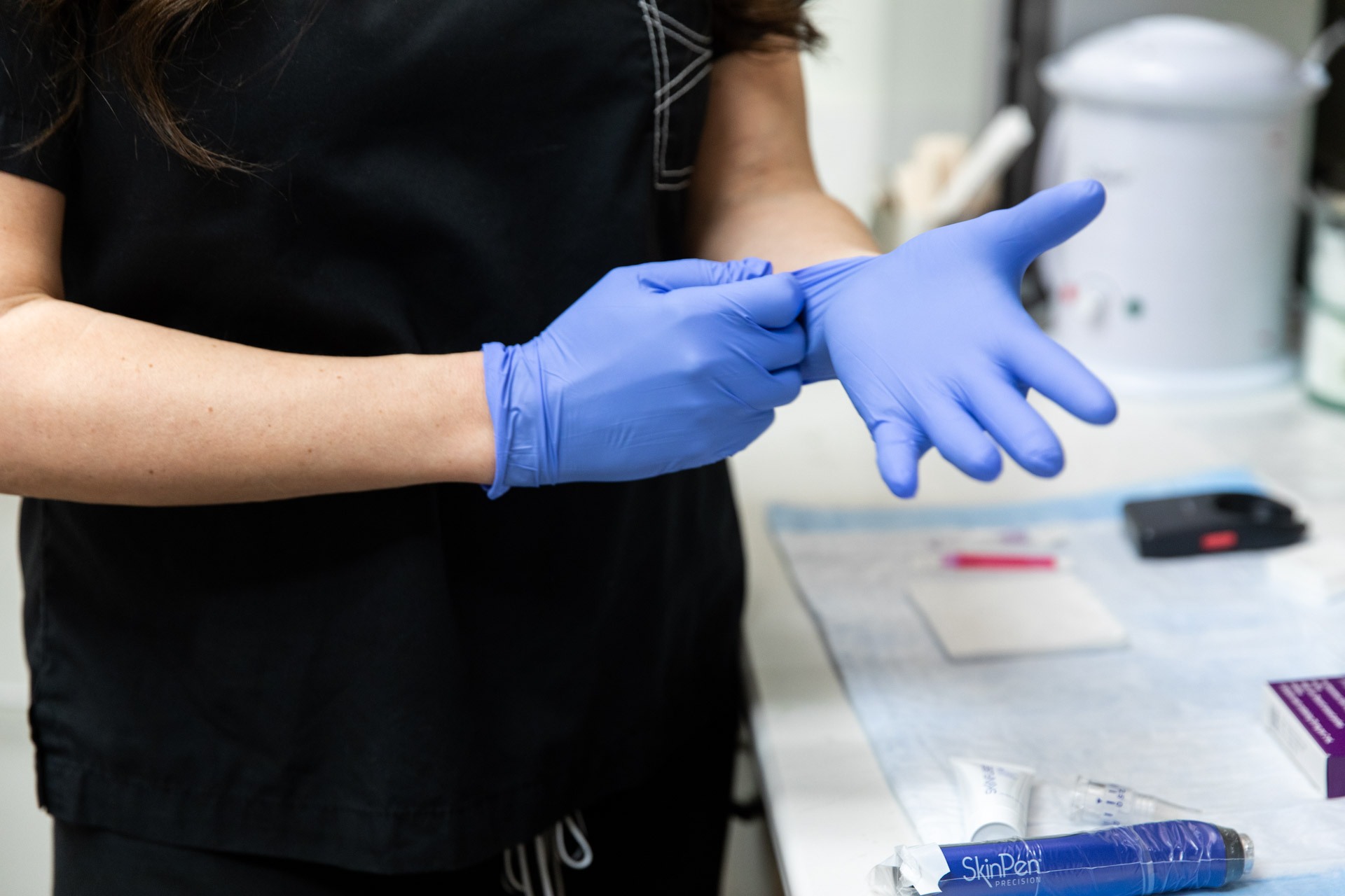 team member putting gloves on