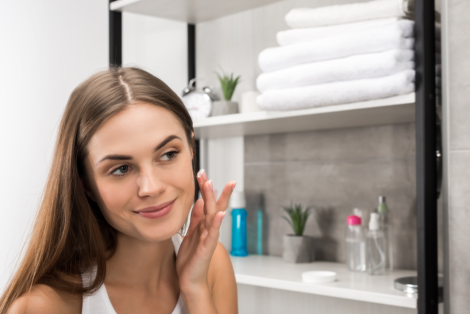 woman using a product on her skin after a skincare consultation in Oklahoma City