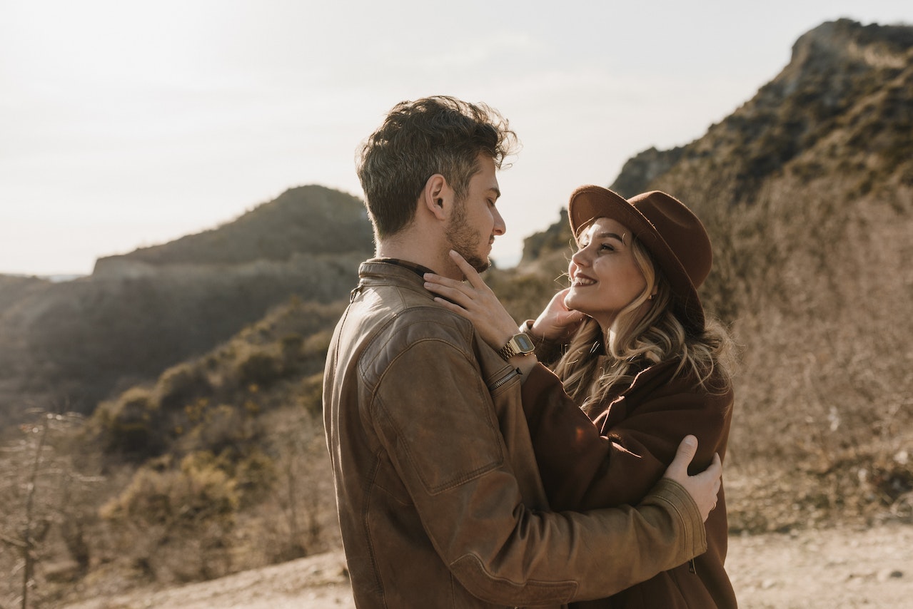 couple embracing on hillside