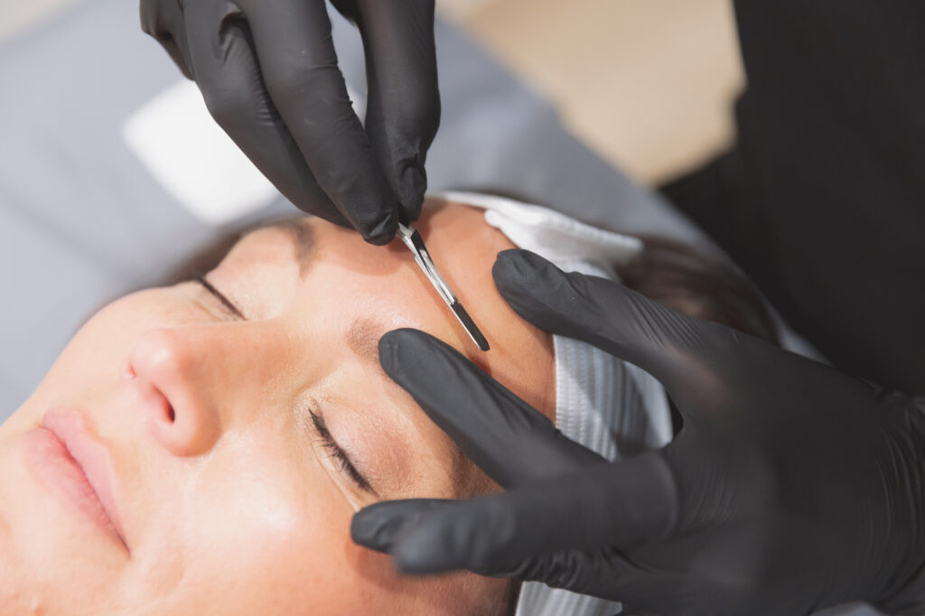 dermaplaning on client face in Oklahoma City