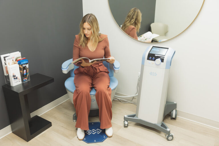 woman sitting on the Emsella chair, undergoing a urinary incontinence treatment in Oklahoma City