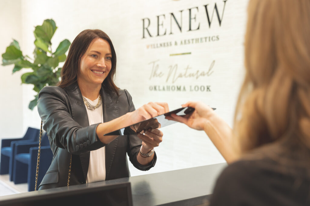 client handing over a clipboard to team member